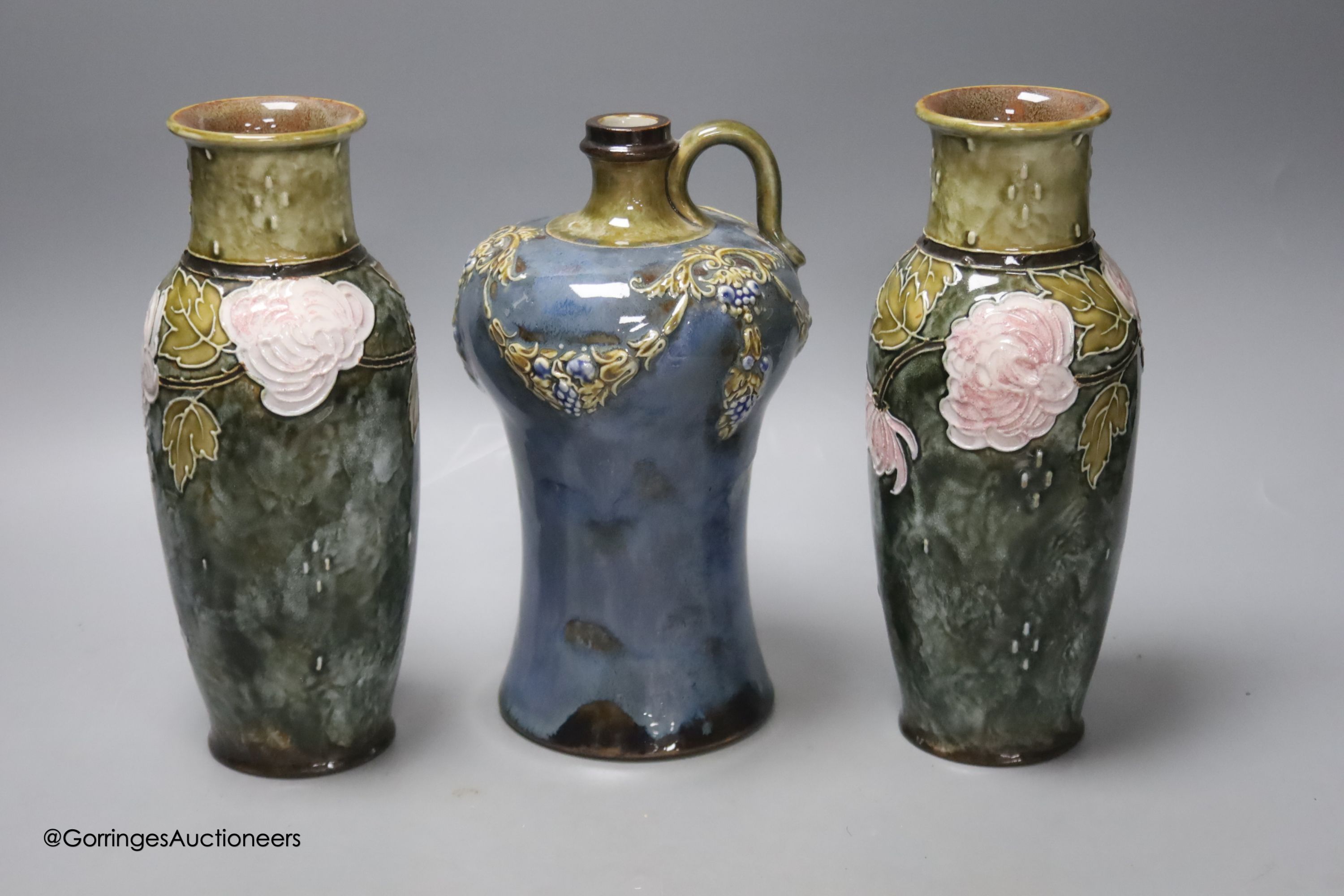 A pair of Doulton vases, 23cm high, together with a Doulton flask, 22cm high (3)